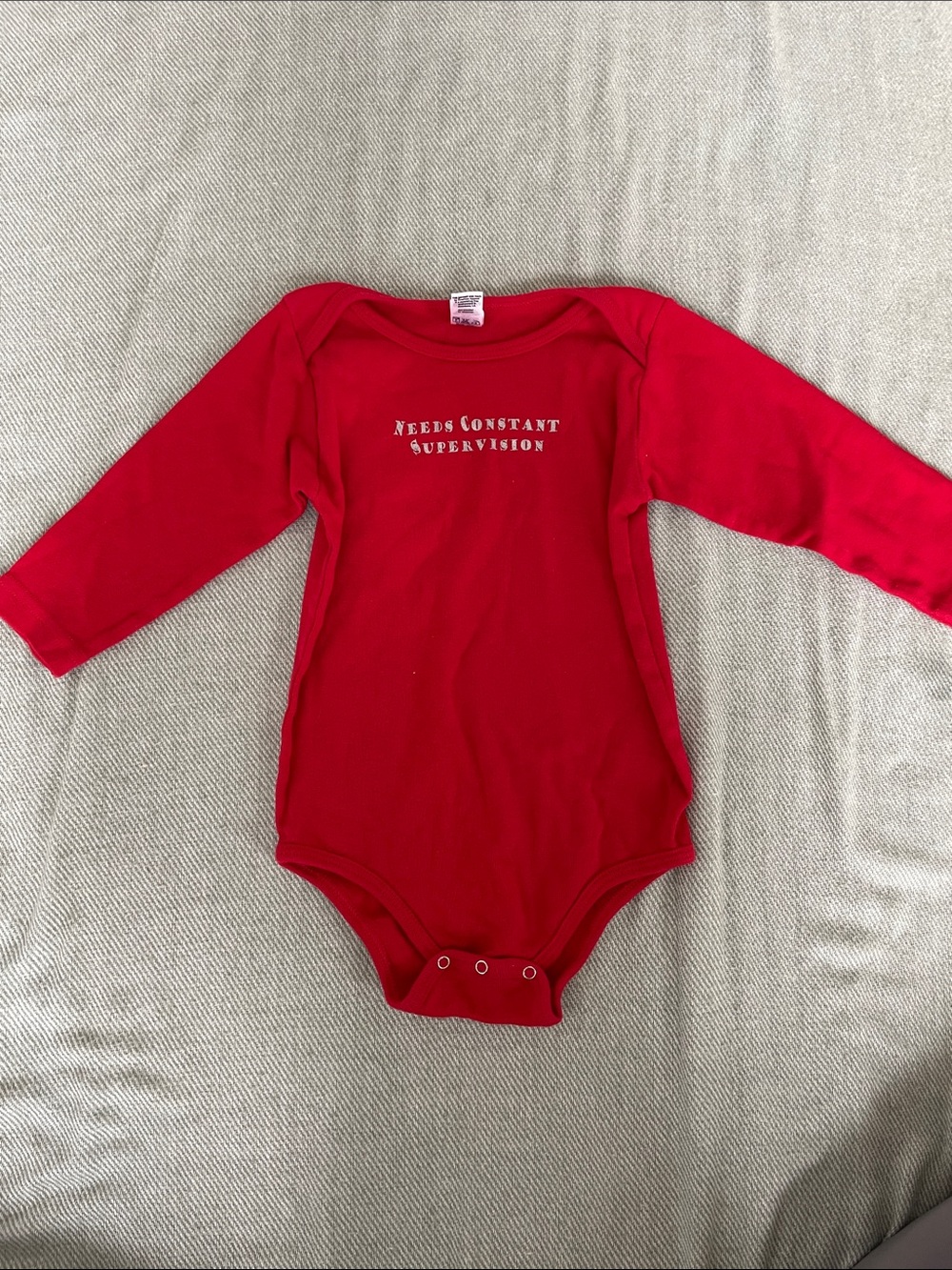 Red Long-Sleeve Baby One-Piece Bodysuit with 'Needs Constant Supervision' Print